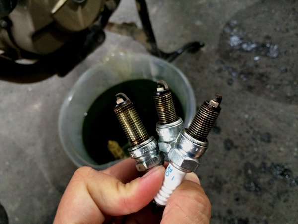 Nat took the time to explain to me that they first took the spark plugs out and looked for telltale signs. The plugs looked good which suggested that the top part of the engine should be okay.