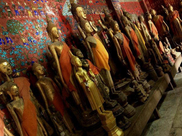 Multiple statues of Buddha of various sizes and heights.