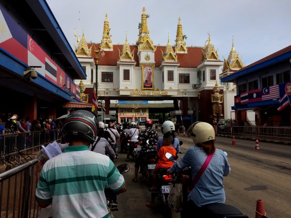 Joining the Thailand immigration queue. Notice the border building has a very distinct Thai-style to it - lots of gold and the King's picture on it.