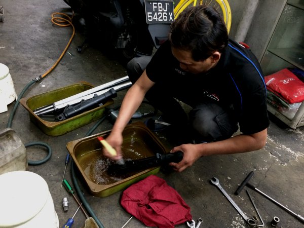 The removed parts getting washed in petrol.